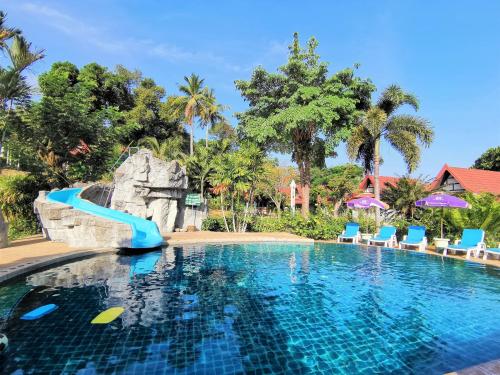 a pool with a water slide in a resort at Holiday Villa, Lanta in Ko Lanta