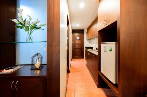 a kitchen with a vase of flowers on a counter at Le Casa Bangsaen in Bangsaen