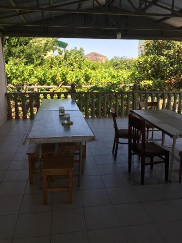 two tables and chairs sitting on a patio at Hasanovs Villa in Baku
