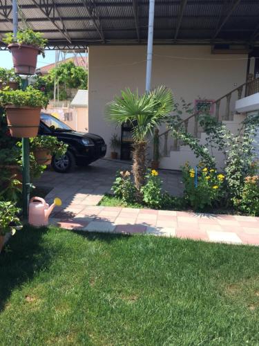 a garden with a car parked in a driveway at Hasanovs Villa in Baku