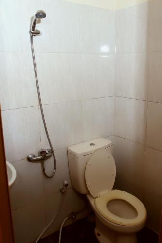 a bathroom with a toilet and a shower at Unique Guesthouse in Bandung
