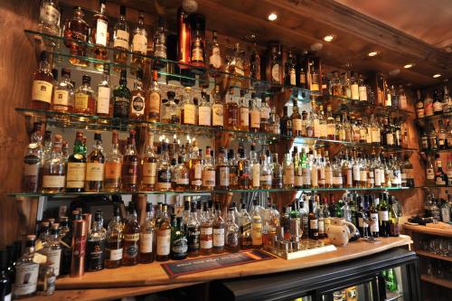 a bar filled with lots of bottles of alcohol at Poppies Hotel in Callander