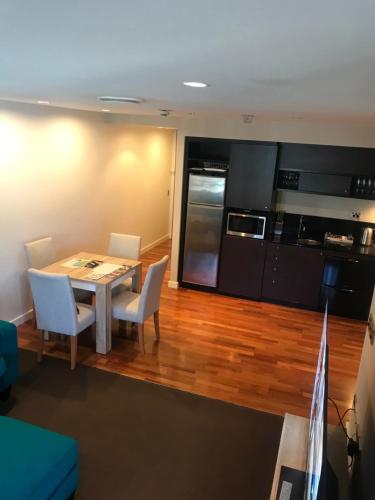 a kitchen and dining room with a table and chairs at Museum Apartment in Wellington
