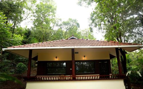 a small house with a tiled roof at Green Garden Wayanad Villas in Vayittiri