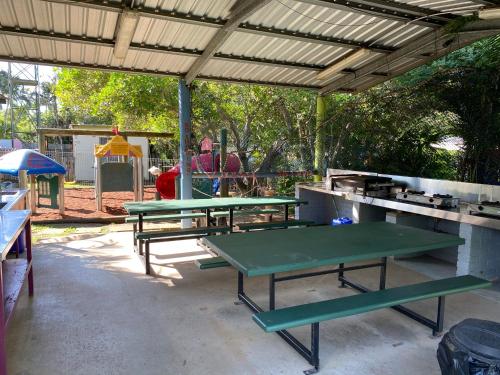 two ping pong tables sitting under a pavilion at Bundaberg Park Village in Bundaberg