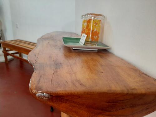 a wooden table with a jar on top of it at Lalanga Homestay in Kandy