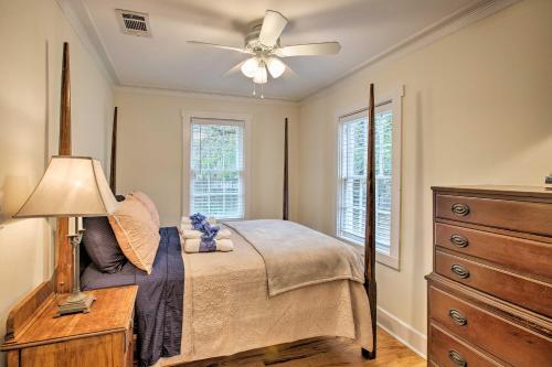 a bedroom with a bed with a ceiling fan and a dresser at Savannah Cottage - 5 Mi to Wormsloe Historic Site! in Savannah