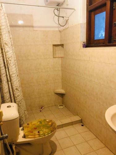 a bathroom with a toilet and a sink at Sunset Beach Residence in Panadura
