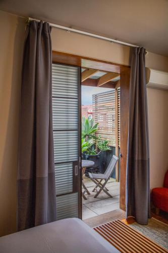 a bedroom with a door open to a patio at Dive Hotel in Sydney