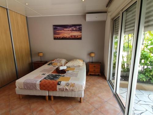 Ένα ή περισσότερα κρεβάτια σε δωμάτιο στο La villa Cocotiers