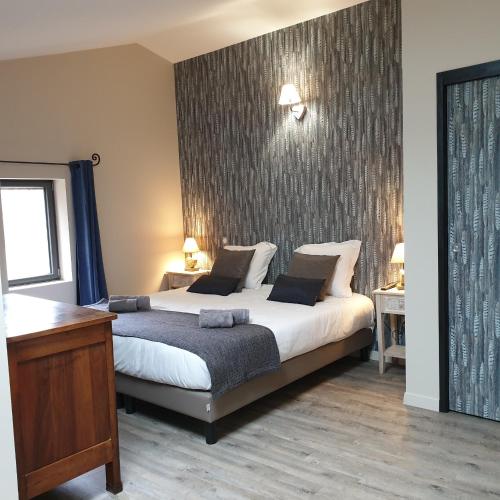 a bedroom with a large bed in a room at Mas de Reilhanette in Montbrun-les-Bains