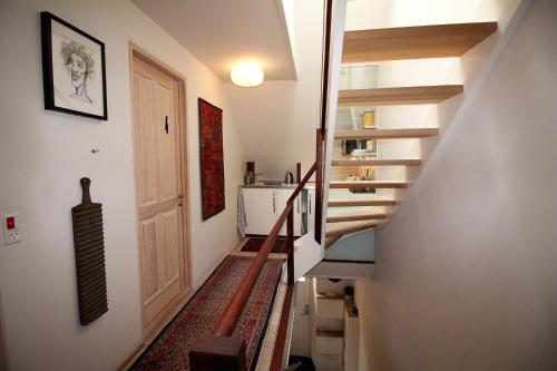 a hallway with a staircase leading up to a door at Odense City B&B in Odense