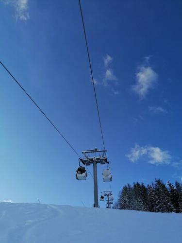 a ski lift with people on it in the snow at Pila vacanze in Gressan