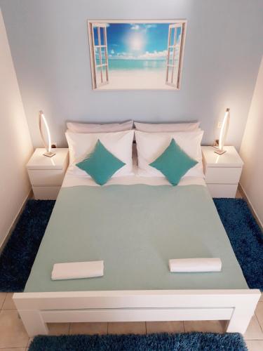 a bedroom with a large bed with pillows at Apartments Darijana in Opatija