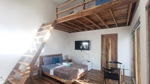 a bedroom with a loft bed and a desk at Island World Panglao in Panglao