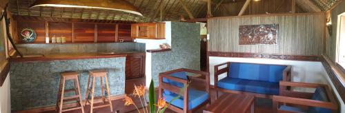a kitchen with a table and chairs in a room at KINTANA LODGE in Ile aux Nattes