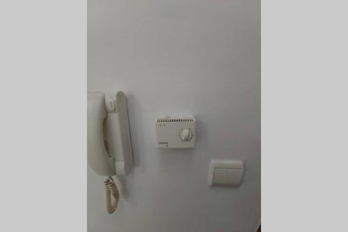 a phone on a wall in a room at City lux apartment 1 in Serres