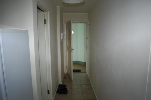 a hallway with a door and a tile floor at On The Beach Front Sea Spray in Bloubergstrand