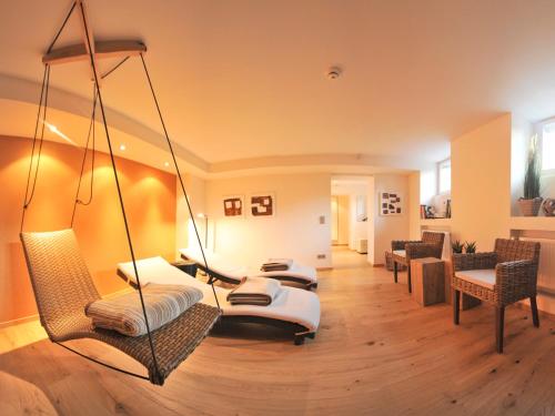 a living room with two swinging beds at Park Villa Hotel in Wuppertal