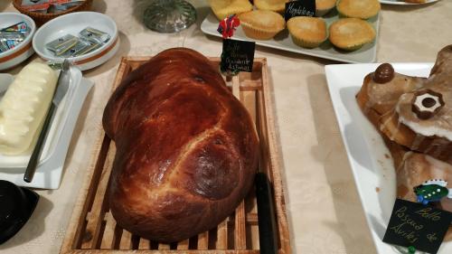 a large loaf of bread sitting on a table with pastries at Hotel Casa Vieja del Sastre in Soto de Luiña
