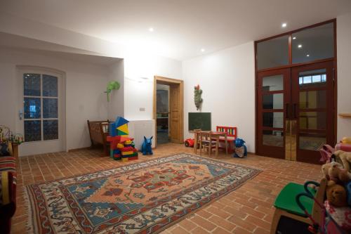 a living room with a rug on the floor at Parkhotel Sole Paradiso in San Candido