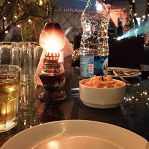 a table with a bowl of food and a lamp at Sher-E-Punjab in Kolkata