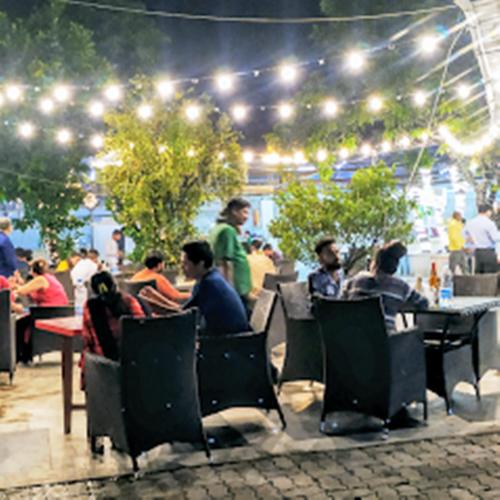a group of people sitting at tables in a restaurant at Sher-E-Punjab in Kolkata