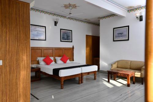 a bedroom with a bed and a couch in a room at Hotel Sunbird in Bharatpur