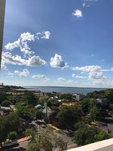 a view of a city with the ocean in the background at Departamento Rodrigo II in Posadas