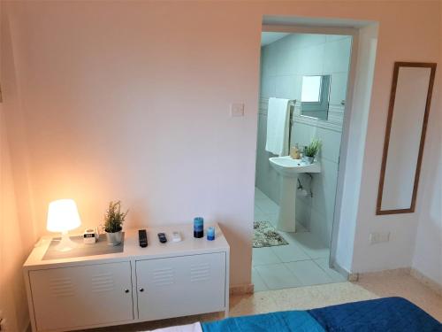 a bathroom with a vanity and a sink and a mirror at Villa Gavriel - Peyia Villa With Breathtaking Sea View, Peyia Villa With Private Pool, Secluded, Huge Outdoor Space, Mountain Views in Peyia