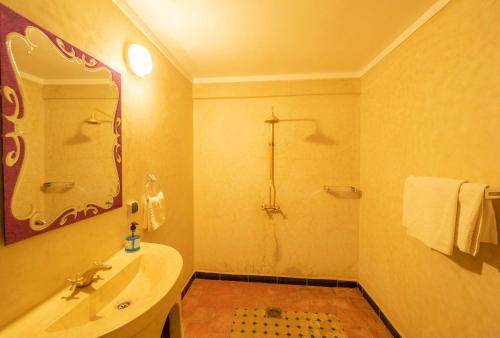 a bathroom with a tub and a sink and a mirror at Riad Rihana Dades in Boumalne Dades