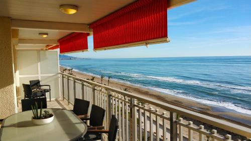 a balcony with a table and a view of the ocean at Torre Hirta 1 in Peniscola