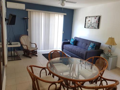a living room with a couch and a glass table at Contry La Silla Apartments zona tec - Nuevo Sur in Monterrey