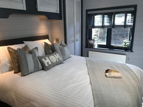 a bedroom with a large white bed with pillows at L11 - The Harlech Lodge with Hot Tub in Bethesda