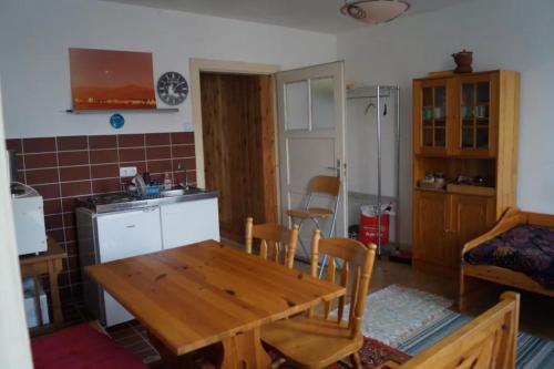 a kitchen and dining room with a wooden table and chairs at CASA-Li old Farmhouse in Tengen