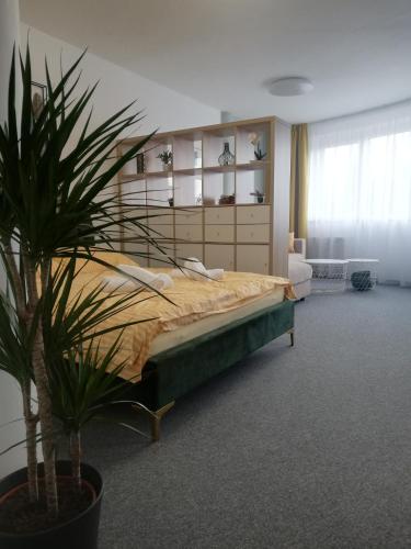 a bedroom with a bed and a potted plant at Apartment MyMara No3 in Bešeňová