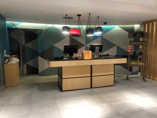 a lobby with a desk with a computer on it at Ibis Madrid Calle Alcalá in Madrid
