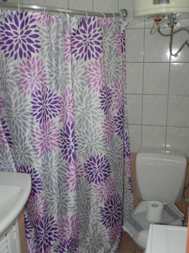 a purple and white shower curtain in a bathroom at Pension Niki in Kalymnos