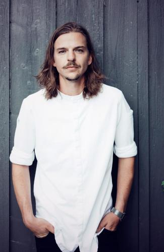 a man with long hair wearing a white shirt at Hotel Haus am See in Nonnenhorn