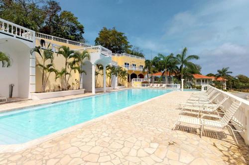 a pool at a resort with lounge chairs at Sunset Villa 3F by Splash Inn in Sandy Bay