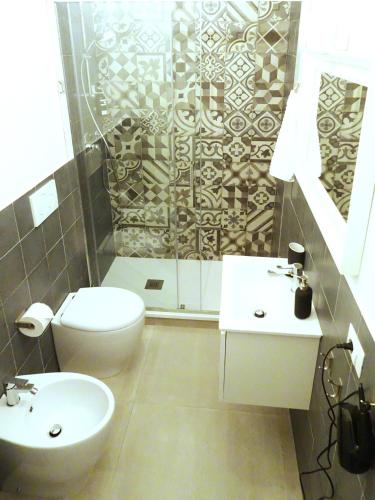 a bathroom with a toilet and a sink and a shower at SMART Rooms Pistoia in Pistoia