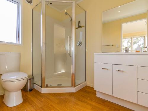 a bathroom with a shower and a toilet and a sink at Kune Crib - Ohakune Holiday Home near Turoa in Ohakune