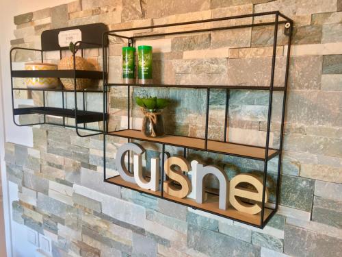 un mur avec des étagères sur un mur de briques et un panneau dans l'établissement MyHome Riviera - Cannes Sea View Apartment Rentals, à Cannes