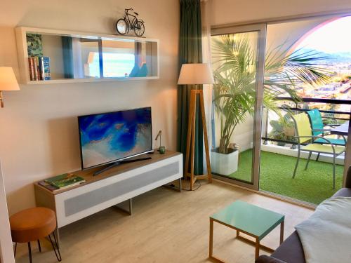 カンヌにあるMyHome Riviera - Cannes Sea View Apartment Rentalsのリビングルーム(薄型テレビ、テーブル付)