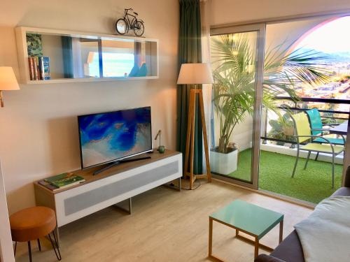 a living room with a flat screen tv on a table at MyHome Riviera - Cannes Sea View Apartment Rentals in Cannes