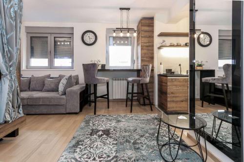 a living room with a couch and a kitchen at Apartment Story,Nikole Cupica Beograd in Belgrade