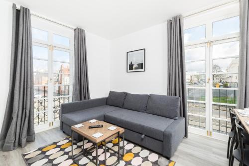 a living room with a couch and a table at Marvel Apartments Leamington Spa in Leamington Spa