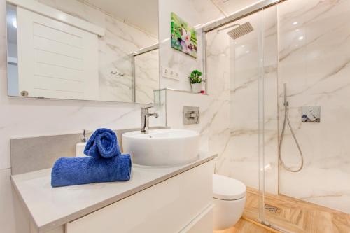 a white bathroom with a sink and a shower at Marlin II Puerto del Carmen in Puerto del Carmen