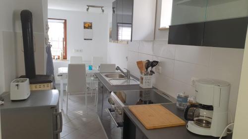 a kitchen with a sink and a coffee maker at Ferienhaus Deubetal Nr.10 in Stadtilm