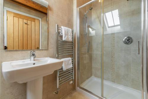 a bathroom with a sink and a shower at Sunflower Cottage - Gonwin Manor in Carbis Bay
